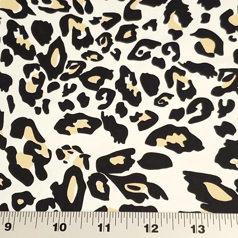 SWIM Fabric: Nylon Spandex Knit, Fun Black, Beige, and White Cheetah Print. Very Nice Quality Activewear and Swimwear. Sold by the 1/2 yard